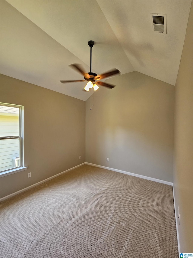 carpeted empty room with visible vents, baseboards, a ceiling fan, and lofted ceiling