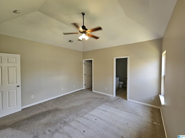 unfurnished bedroom with ensuite bathroom, visible vents, vaulted ceiling, carpet floors, and baseboards