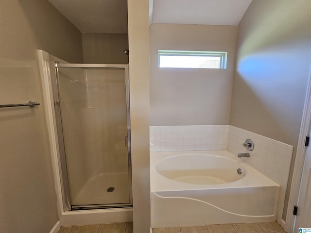 bathroom featuring tile patterned floors, a garden tub, and a stall shower