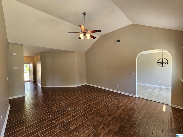 unfurnished living room featuring dark wood-type flooring, arched walkways, a ceiling fan, vaulted ceiling, and visible vents