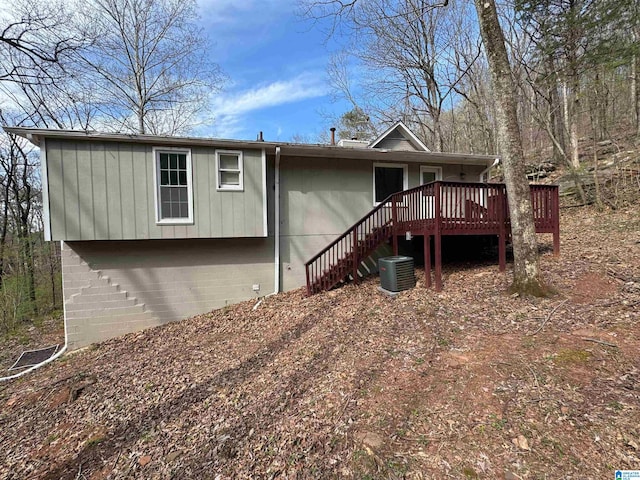 back of property featuring a wooden deck, cooling unit, and stairway