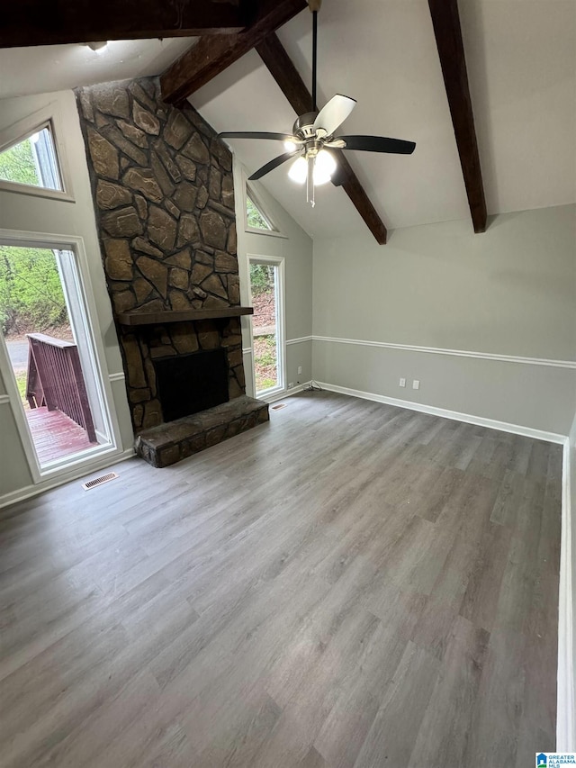 unfurnished living room with visible vents, wood finished floors, and a healthy amount of sunlight