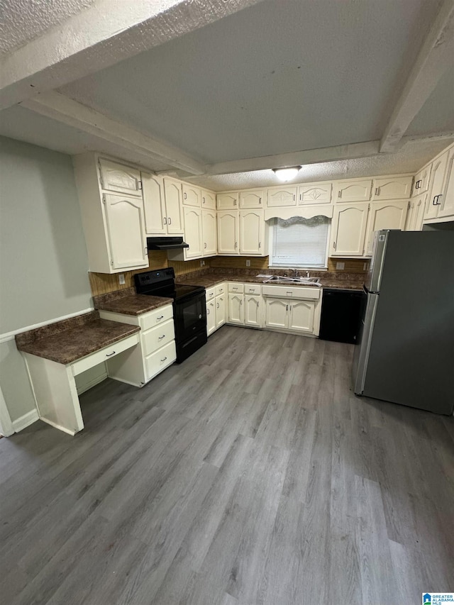 kitchen featuring black / electric stove, white cabinetry, freestanding refrigerator, dark wood finished floors, and a sink