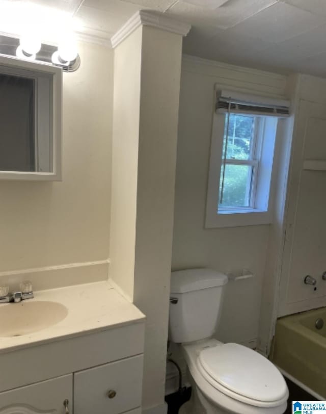 full bath featuring ornamental molding, toilet, and vanity