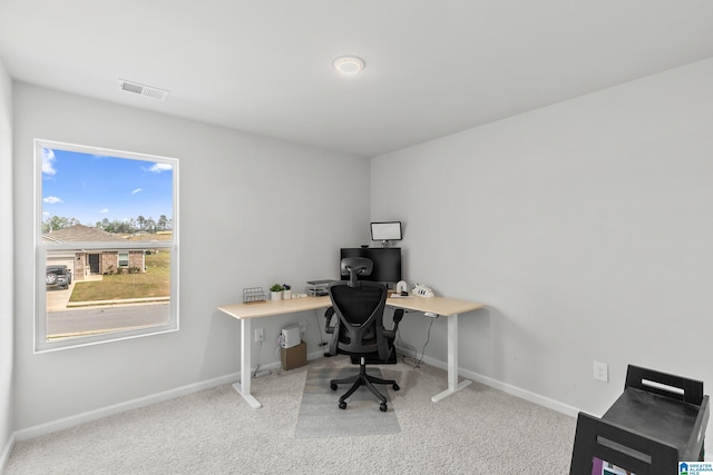home office featuring carpet floors, visible vents, and baseboards