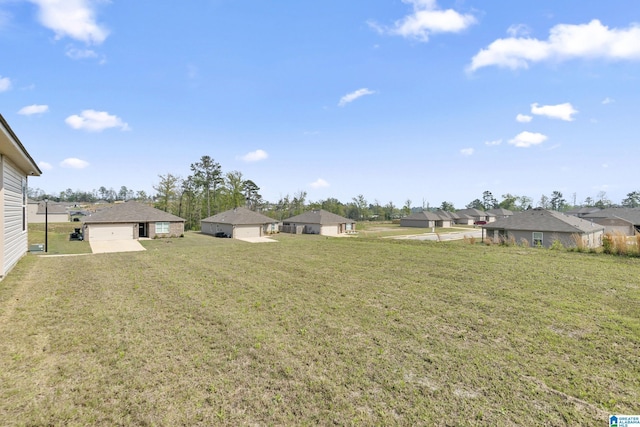 view of yard with a garage and a residential view