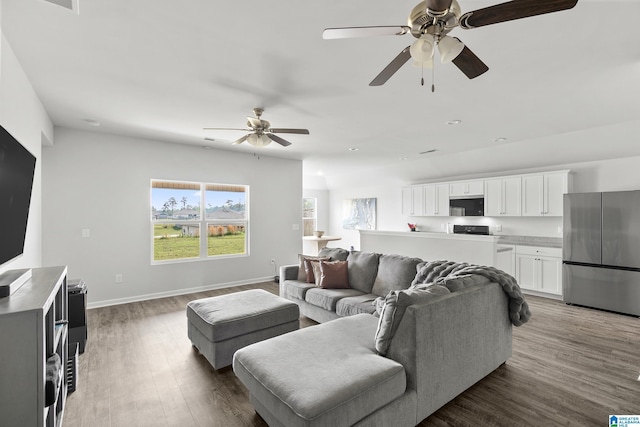 living area with wood finished floors, baseboards, and ceiling fan