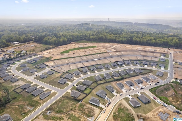 drone / aerial view with a forest view and a residential view