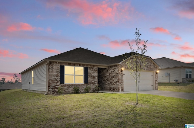 single story home with brick siding, a yard, an attached garage, and driveway