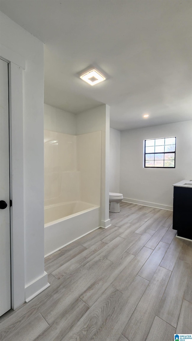full bathroom featuring toilet, vanity, wood finished floors, and baseboards