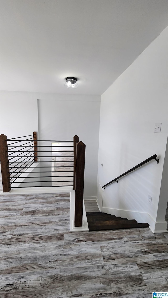 stairs featuring baseboards and wood finished floors