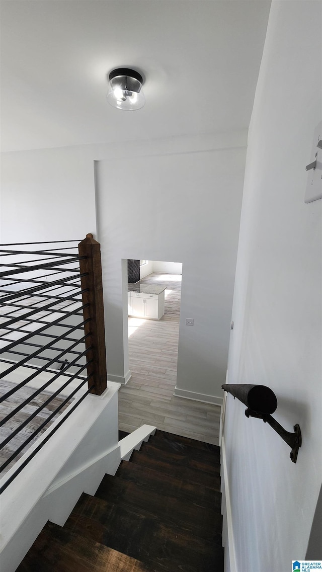 stairs featuring baseboards and wood finished floors