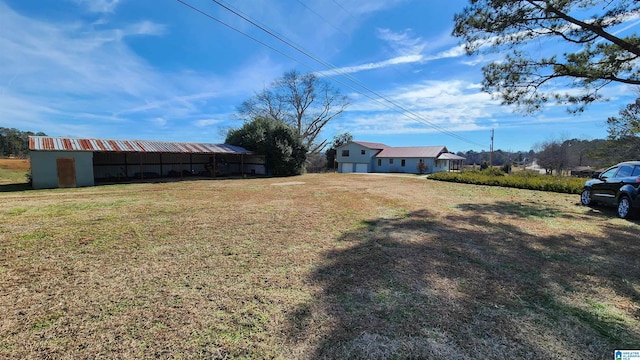 view of yard with an outbuilding and a pole building