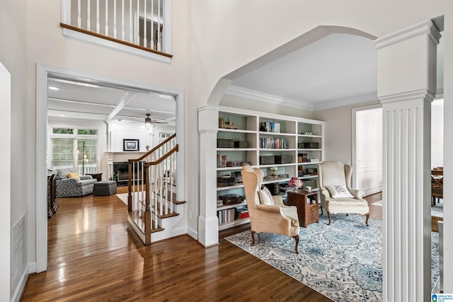 5006 Aberdeen Way, Hoover, AL 35242 - living area with ornate columns, wood finished floors, a ceiling fan, and arched walkways