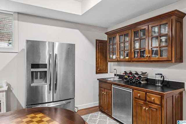 5006 Aberdeen Way, Hoover, AL 35242 - kitchen featuring glass insert cabinets, refrigerator, stainless steel refrigerator with ice dispenser, dark countertops, and a sink