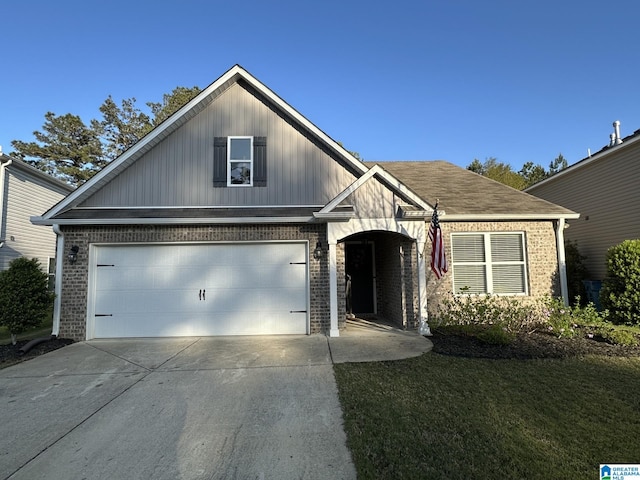 view of front of house with brick siding, driveway, and a front yard