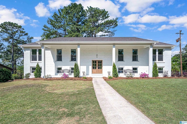 bi-level home featuring a porch and a front lawn