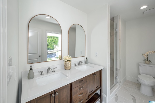 full bathroom featuring a sink, toilet, a shower stall, and marble finish floor