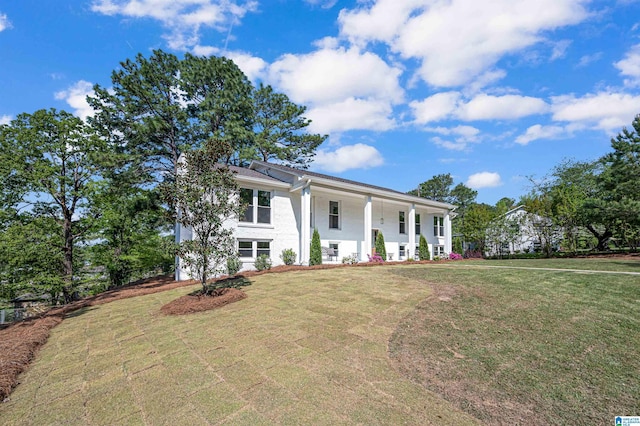 view of front of house with a front yard and covered porch
