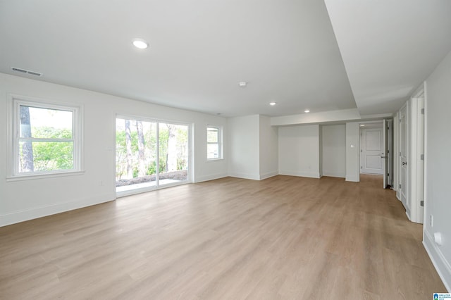 unfurnished living room with recessed lighting, light wood-style floors, baseboards, and visible vents