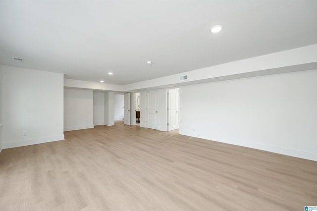 interior space featuring light wood-style floors, recessed lighting, visible vents, and baseboards
