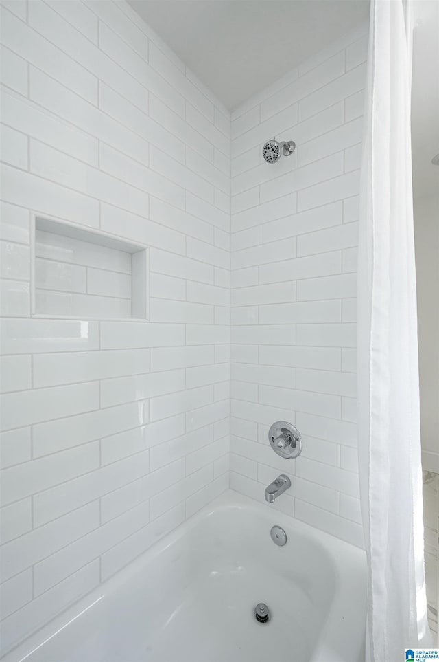 bathroom with shower / bath combination with curtain