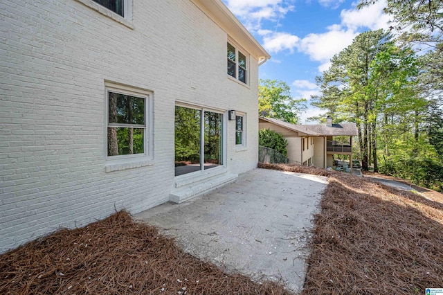 exterior space featuring a patio area and brick siding