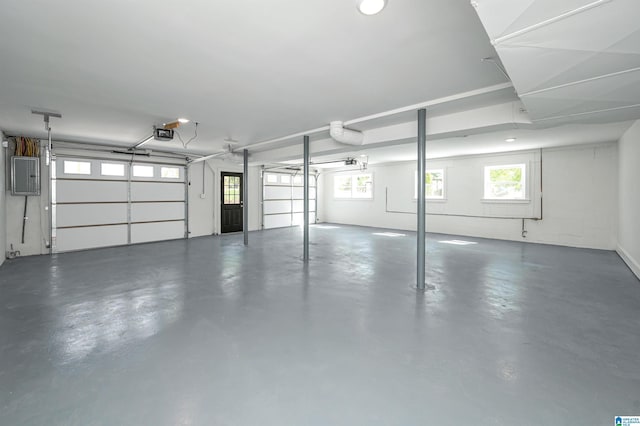 garage featuring electric panel and a garage door opener