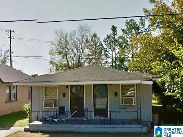 view of front of home with a porch and cooling unit