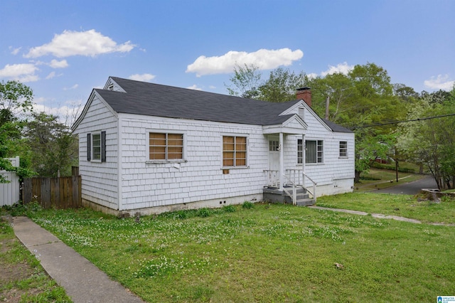 view of front facade with crawl space, a chimney, fence, and a front lawn