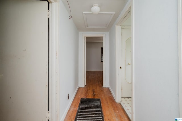 hallway with light wood-style flooring and baseboards