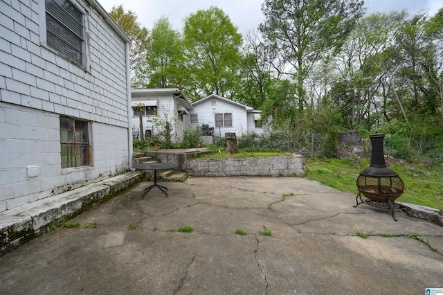 view of patio / terrace with a fire pit and fence
