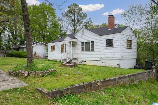 view of front of property with crawl space, a chimney, and a front lawn
