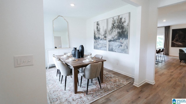 dining room with recessed lighting, baseboards, and wood finished floors