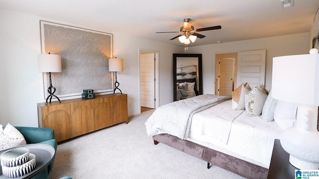 bedroom featuring light carpet, visible vents, and ceiling fan