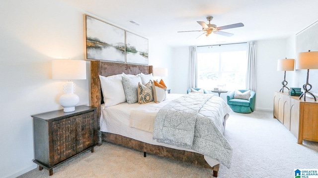 carpeted bedroom featuring visible vents, baseboards, and a ceiling fan