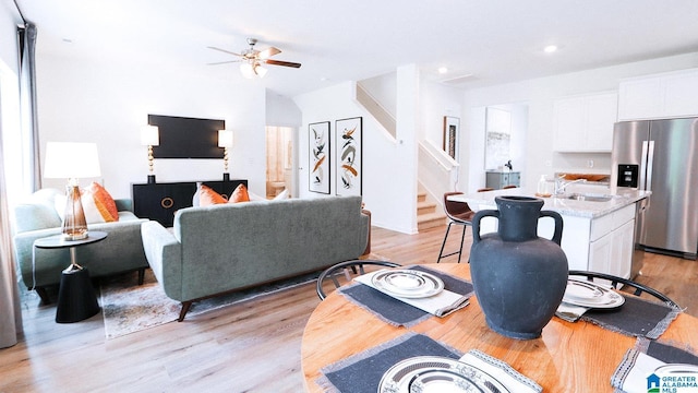living room with recessed lighting, stairway, light wood-style flooring, and ceiling fan