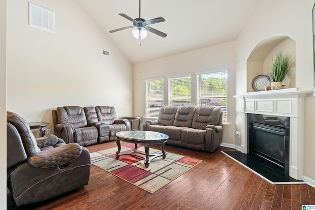 living room with high vaulted ceiling, visible vents, hardwood / wood-style floors, and ceiling fan