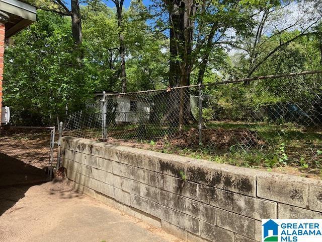 view of home's community featuring a gate and fence