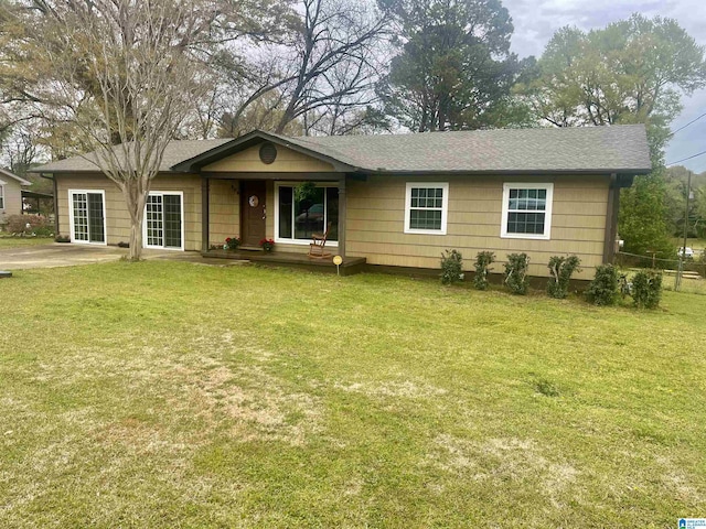 single story home featuring a front yard and roof with shingles
