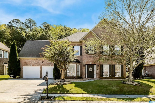 5544 Colony Ln, Hoover, AL 35226 - colonial house with a garage, roof with shingles, a front yard, brick siding, and driveway