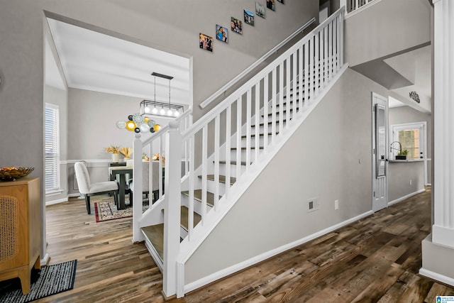 5544 Colony Ln, Hoover, AL 35226 - stairs featuring wood finished floors, an inviting chandelier, baseboards, and ornamental molding