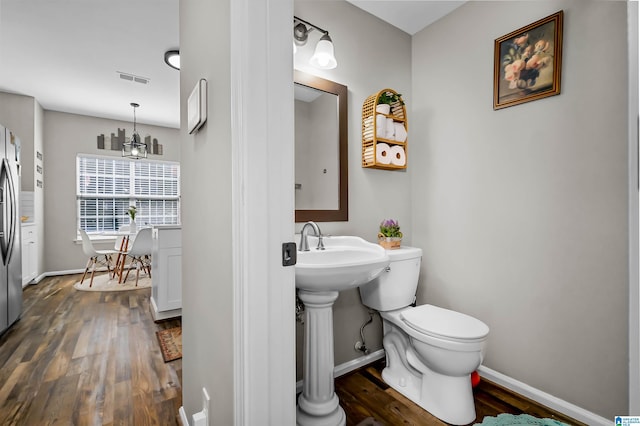 5544 Colony Ln, Hoover, AL 35226 - half bathroom featuring visible vents, baseboards, toilet, and wood finished floors