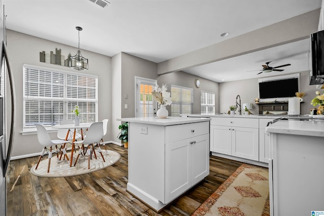 5544 Colony Ln, Hoover, AL 35226 - kitchen featuring dark wood finished floors, a center island, white cabinets, ceiling fan, and hanging light fixtures