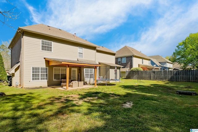 5544 Colony Ln, Hoover, AL 35226 - back of property with a trampoline, a patio area, fence, and a lawn