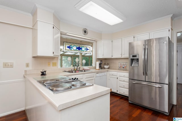 kitchen featuring a sink, light countertops, dark wood finished floors, stainless steel appliances, and backsplash