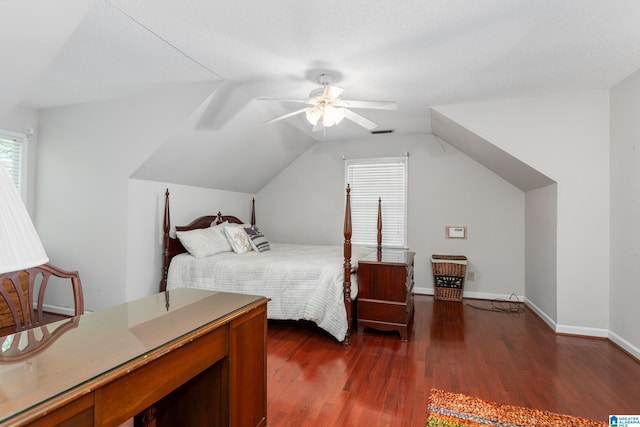 bedroom featuring dark wood-style flooring, baseboards, vaulted ceiling, visible vents, and ceiling fan