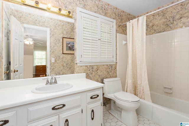 bathroom with a ceiling fan, toilet, a textured ceiling, and wallpapered walls