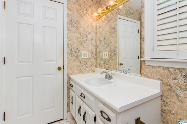 bathroom featuring vanity and wallpapered walls