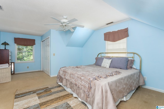 carpeted bedroom featuring visible vents, baseboards, and lofted ceiling